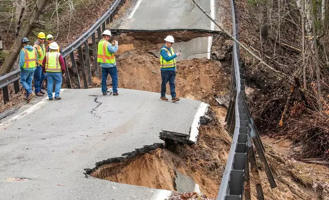 A team from the Michigan Department of Transportation inspects a washed-out bridge on M-119 between Division and Island View Roads, south of Cross Village, Mich., in Emmett County on Monday, April 13, 2026. (Jan-Michael Stump/Traverse City Record-Eagle via AP)