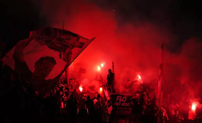 PSG fans light flares on the stands during a Champions League semifinal, first leg, soccer match between Paris Saint-Germain and Bayern Munich in Paris, Tuesday, April 28, 2026. (AP Photo/Aurelien Morissard)