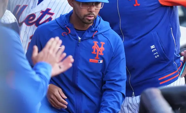 New York Mets manager Carlos Mendoza looks over the dugout during the fifth inning of the second baseball game of a doubleheader against the Colorado Rockies, Sunday, April 26, 2026, in New York. (AP Photo/Seth Wenig)