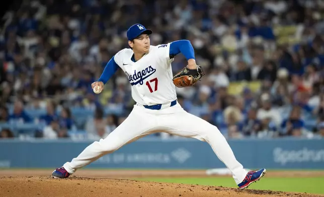 Los Angeles Dodgers starting pitcher Shohei Ohtani delivers during the second inning of a baseball game against the Cleveland Guardians in Los Angeles, Tuesday, March 31, 2026. (AP Photo/Kyusung Gong)
