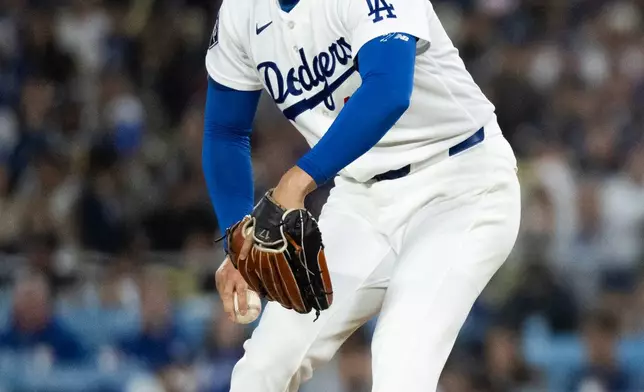 Los Angeles Dodgers starting pitcher Shohei Ohtani delivers during the second inning of a baseball game against the Cleveland Guardians in Los Angeles, Tuesday, March 31, 2026. (AP Photo/Kyusung Gong)