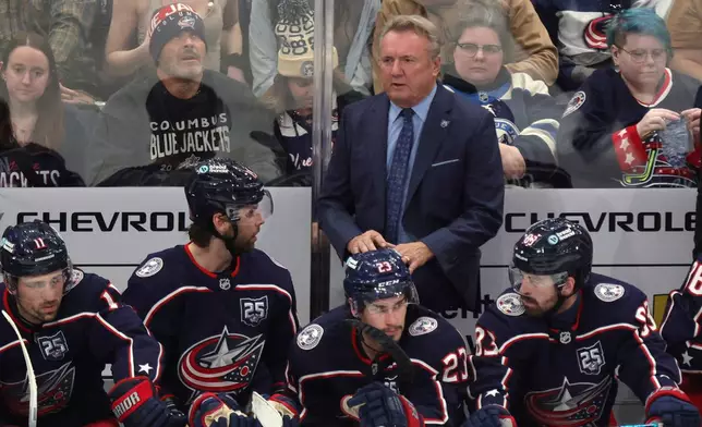 Columbus Blue Jackets coach Rick Bowness, center top, looks on during the third period of an NHL hockey game against the Winnipeg Jets in Columbus, Ohio, Saturday, April 4, 2026. (AP Photo/Paul Vernon)