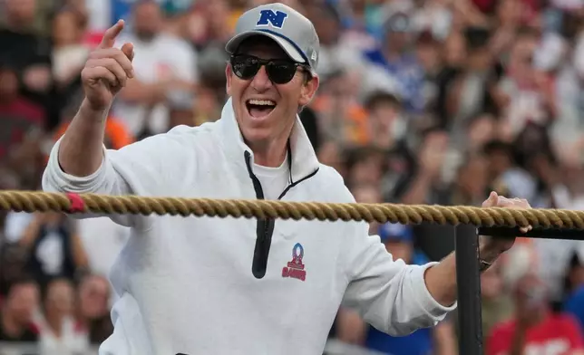 FILE - NFC coach Eli Manning cheers on his players during the tug of war event at the NFL Pro Bowl football game in Orlando, Fla., Feb. 2, 2025. (AP Photo/John Raoux, File)