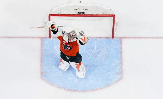Philadelphia Flyers goalie Dan Vladar reacts after a win in an NHL hockey game against the Carolina Hurricanes, Monday, April 13, 2026, in Philadelphia. (AP Photo/Chris Szagola)