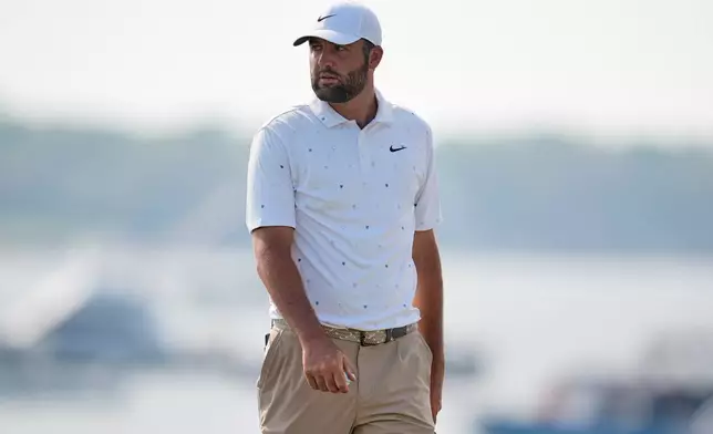 Scottie Scheffler walks across the 18th green during the third round of the RBC Heritage golf tournament Saturday, April 18, 2026, in Hilton Head, S.C. (AP Photo/Mike Stewart)