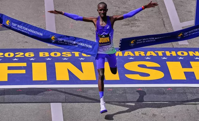 John Korir, of Kenya, breaks the tape to win the Boston Marathon, Monday, April 20, 2026, in Boston. (AP Photo/Charles Krupa)