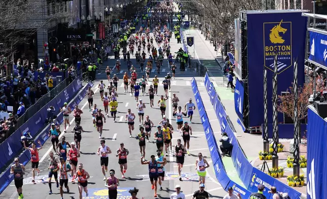 FILE - Runners approach the finish line during the Boston Marathon, April 21, 2025, in Boston. (AP Photo/Charles Krupa, File)
