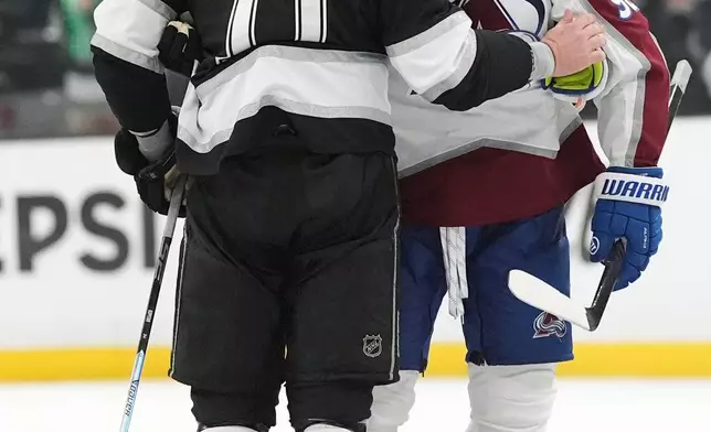 Colorado Avalanche's Gabriel Landeskog, right, greets Los Angeles Kings' Anze Kopitar (11) after Kopitar's final game of his career during Game 4 in the first round of an NHL hockey Stanley Cup playoff series Sunday, April 26, 2026, in Los Angeles. (AP Photo/Scott Strazzante)