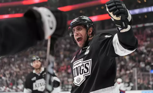Los Angeles Kings' Anze Kopitar (11) celebrates a goal by Joel Edmundson against the Colorado Avalanche during the second period of Game 4 in the first round of an NHL hockey Stanley Cup playoff series Sunday, April 26, 2026, in Los Angeles. (AP Photo/Scott Strazzante)
