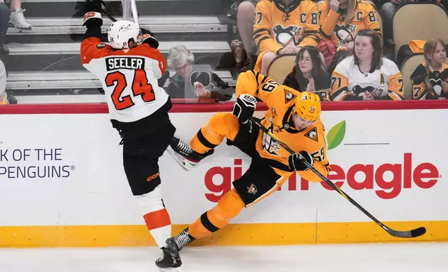 Philadelphia Flyers' Nick Seeler (24) collides with Pittsburgh Penguins' Egor Chinakhov during the first period of Game 1 in the first round of the NHL Stanley Cup playoffs in Pittsburgh, Saturday, April 18, 2026. (AP Photo/Gene J. Puskar)