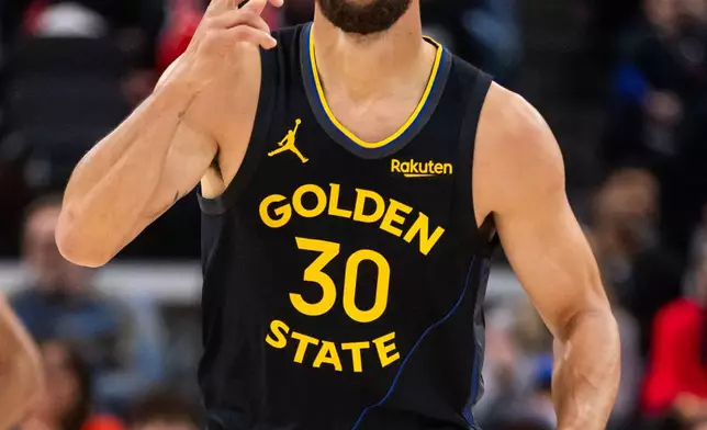 Golden State Warriors guard Stephen Curry gestures after scoring against the Los Angeles Clippers during the first half of an NBA basketball game, Sunday, April 12, 2026, in Inglewood, Calif. (AP Photo/Ethan Swope)