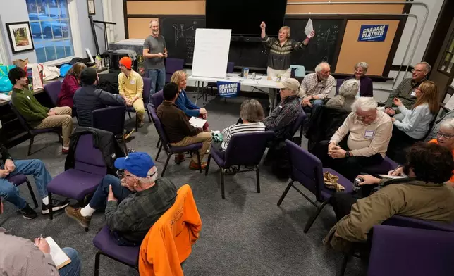 Joanie Monteith leads a trivia night for supporters of U.S. Senate candidate Graham Platner, Thursday, March 26, 2026, in Kittery, Maine. (AP Photo/Robert F. Bukaty)