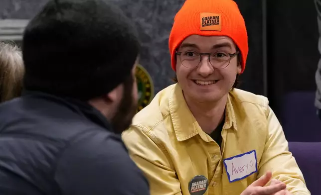 Avery Seuter talks with a fellow supporter of US Senate candidate Graham Platner during a Platner-themed trivia night, Thursday, March 26, 2027, in Kittery, Maine. (AP Photo/Robert F. Bukaty)