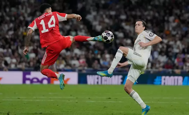 Real Madrid's Alvaro Carreras, right, and Bayern's Luis Diaz challenge for the ball during the Champions League quarterfinal first leg soccer match between Real Madrid and Bayern Munich in Madrid, Spain, Tuesday, April 7, 2026. (AP Photo/Bernat Armangue)