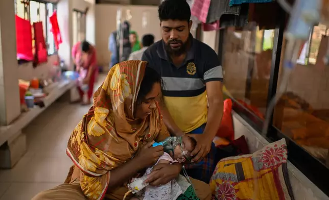 A mother administers a nebulizer treatment for her child suffering from measles at the Infectious Diseases Hospital in Dhaka, Bangladesh, Monday, April 6, 2026, amid a countrywide outbreak. (AP Photo/Mahmud Hossain Opu)