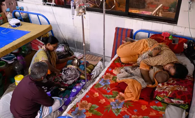 Families take care of their children receiving treatment for measles at the Infectious Diseases Hospital in Dhaka, Bangladesh, Monday, April 6, 2026, amid a countrywide outbreak. (AP Photo/Mahmud Hossain Opu)