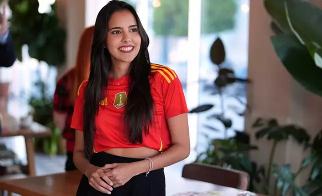 Artist Lili Cantero looks on during the launch of the Wynwood United Soccer Ball Art Trail, which will showcase hand-painted soccer balls honoring historic World Cup championships inside local businesses, April 8, 2026, at Rodilla cafe in the Wynwood district of Miami. (AP Photo/Rebecca Blackwell)