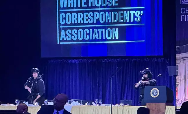 U.S. Secret Service agents respond on stage during the White House Correspondents Dinner, Saturday, April 25, 2026, in Washington. (AP Photo/Alex Brandon)