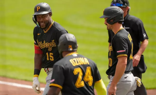 Pittsburgh Pirates' Oneil Cruz, left, Marcell Ozuna, center, and Bryan Reynolds, right, after hitting a three-run homer in the first inning of a baseball game against the Cincinnati Reds in Cincinnati, Wednesday, April 1, 2026. (AP Photo/Carolyn Kaster)