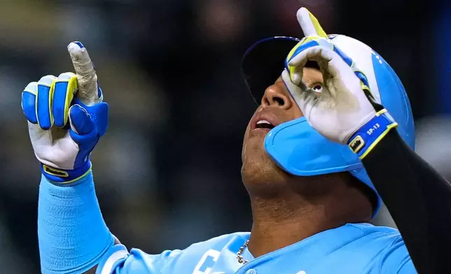 Kansas City Royals' Salvador Perez celebrates after hitting a solo home run during the sixth inning in the second baseball game of a doubleheader against the Milwaukee Brewers, Saturday, April 4, 2026, in Kansas City, Mo. (AP Photo/Charlie Riedel)