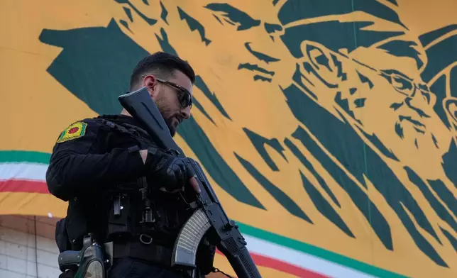 A police officer stands guard in front of a banner with portraits of the late Iranian revolutionary founder Ayatollah Khomeini, left, and late Supreme Leader Ayatollah Ali Khamenei in a state-organised rally celebrating the birthday of Imam Reza, the 8th Shiite Muslims' Imam, and supporting the supreme leader, in Tehran, Iran, Wednesday, April 29, 2026. (AP Photo/Vahid Salemi)