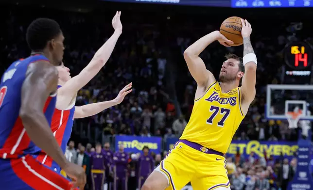 Los Angeles Lakers guard Luka Doncic (77) looks to make a shot-attempt in the fourth quarter of a loss to the Detroit Pistons in an NBA basketball game Monday, March 23, 2026, in Detroit. (AP Photo/Duane Burleson)