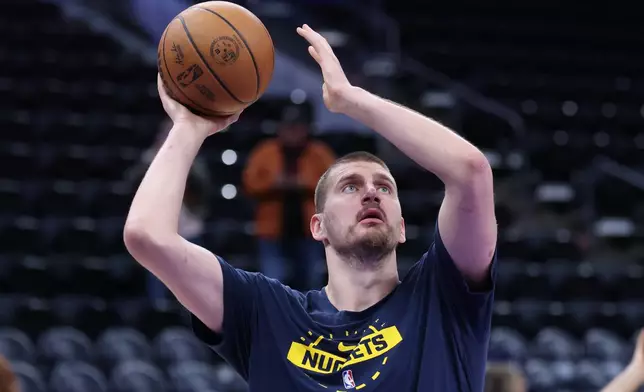 Denver Nuggets center Nikola Jokic warms up before an NBA basketball game against the Utah Jazz, Wednesday, April 1, 2026, in Salt Lake City. (AP Photo/Rob Gray)