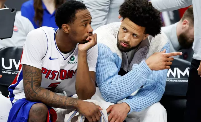 Detroit Pistons forward Ronald Holland II (5) talks with guard Cade Cunningham (2), who did not play due to an injury, during the second half of an NBA basketball game against the Toronto Raptors Tuesday, March 31, 2026, in Detroit. (AP Photo/Duane Burleson)