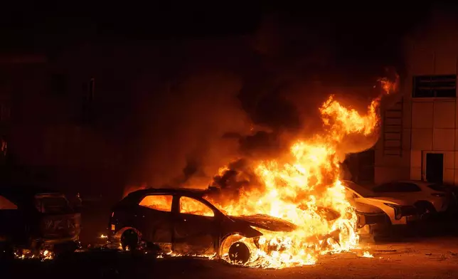 Cars burn after a Russian strike in Kyiv, Ukraine, on Thursday, April 16, 2026. (AP Photo/Evgeniy Maloletka)