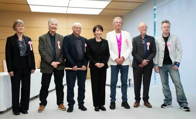 Japan's Prime Minister Sanae Takaichi, poses with members of British rock band Deep Purple, Don Airey, second left, Ian Paice, third left, Ian Gillan, third right, Roger Glover, second right Simon McBrideat, right, and British Ambassador to Japan Julia Longbottom, left, during their meeting the Prime Minister's Office in Tokyo, Friday, April 10, 2026. (Yuichi Yamazaki/Pool Photo via AP)