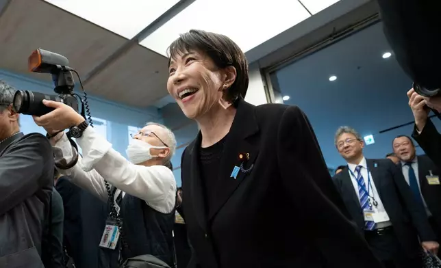 Japan's Prime Minister Sanae Takaichi, arrives for a meeting with members of British rock band Deep Purple at the Prime Minister's Office in Tokyo, Friday, April 10, 2026. (Yuichi Yamazaki/Pool Photo via AP)