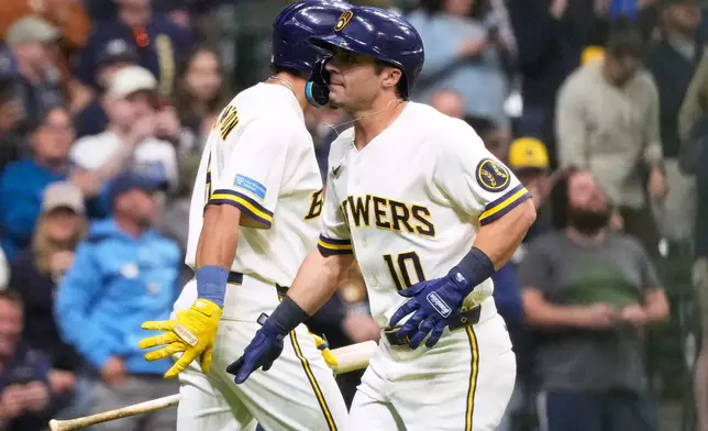 Milwaukee Brewers' Sal Frelick, right, celebrates with David Hamilton after hitting a solo home run during the second inning of a baseball game against the Arizona Diamondbacks, Tuesday, April 28, 2026, in Milwaukee. (AP Photo/Nam Y. Huh)