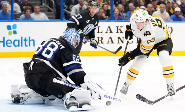 Tampa Bay Lightning goaltender Andrei Vasilevskiy (88) stops a shot by Boston Bruins center Fraser Minten (93) stops a shot by during the first period of an NHL hockey game Saturday, April 4, 2026, in Tampa, Fla. (AP Photo/Chris O'Meara)
