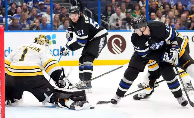 Boston Bruins goaltender Jeremy Swayman (1) makes a pad save on a shot by Tampa Bay Lightning right wing Corey Perry (10) during the second period of an NHL hockey game Saturday, April 4, 2026, in Tampa, Fla. (AP Photo/Chris O'Meara)