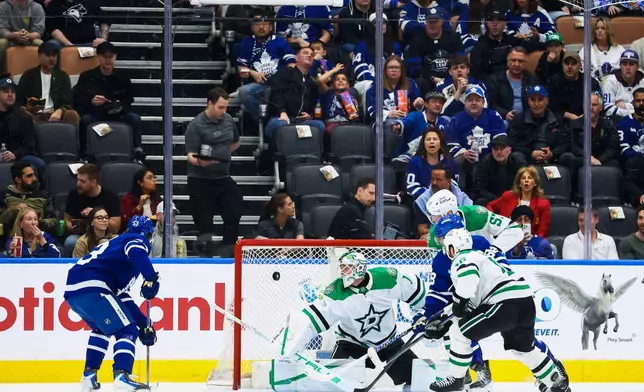 Toronto Maple Leafs right wing William Nylander (88) scores a goal on Dallas Stars goaltender Casey DeSmith (1) during the first period of an NHL hockey game, in Toronto, Monday, April 13, 2026. (Cole Burston/The Canadian Press via AP)