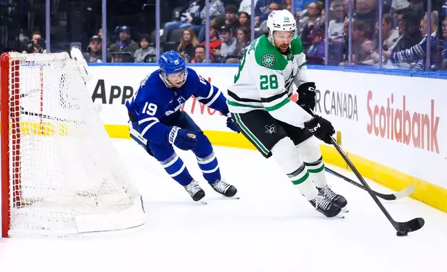 Toronto Maple Leafs center Calle Jarnkrok (19) chases Dallas Stars defenseman Alexander Petrovic (28) who brings the puck around the net during second-period NHL hockey game action in Toronto, Monday, April 13, 2026. (Cole Burston/The Canadian Press via AP)