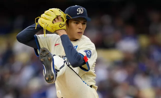 Los Angeles Dodgers starting pitcher Roki Sasaki throws to the plate during the first inning of a baseball game against the Chicago Cubs, Saturday, April 25, 2026, in Los Angeles. (AP Photo/Mark J. Terrill)