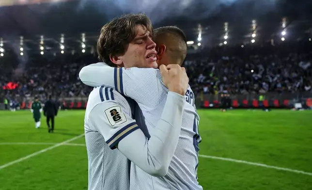 Italy's Marco Palestra, left, and Leonardo Spinazzola console each other after losing a penalty shootout during the World Cup qualifying playoff final soccer match between Bosnia and Italy in Zenica, Bosnia, Tuesday, March 31, 2026. (AP Photo/Armin Durgut)