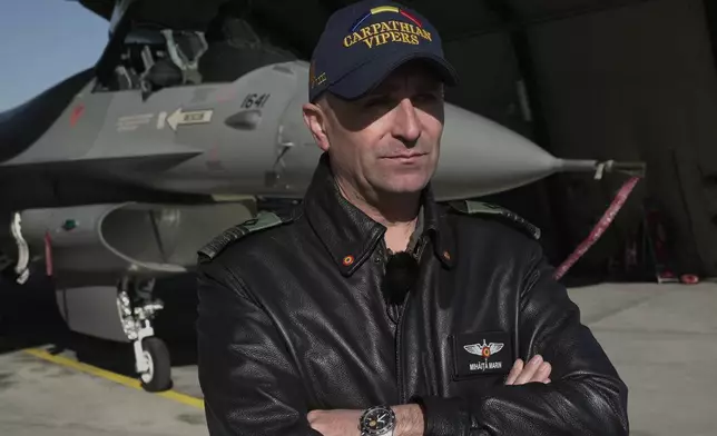 Romanian air force Col. Mihaita Marin, commander of a Romanian air wing of F-16 fighter jets deployed at the Siauliai Air Base in Lithuania on a NATO air-policing mission, speaks during an interview on Monday, April 20, 2026. (AP Photo/John Leicester)