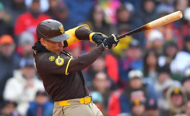 San Diego Padres' Freddy Fermin hits a one-run double allowing Miguel Andujar to score in the third inning of a baseball game against the Boston Red Sox, Saturday, April 4, 2026, in Boston. (AP Photo/Steven Senne)