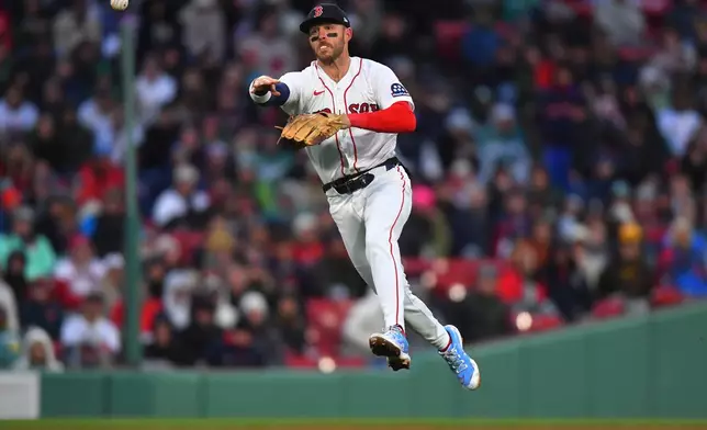 Boston Red Sox shortstop Trevor Story throws to first base to retire San Diego Padres' Ty France in the eighth inning of a baseball game, Saturday, April 4, 2026, in Boston. (AP Photo/Steven Senne)