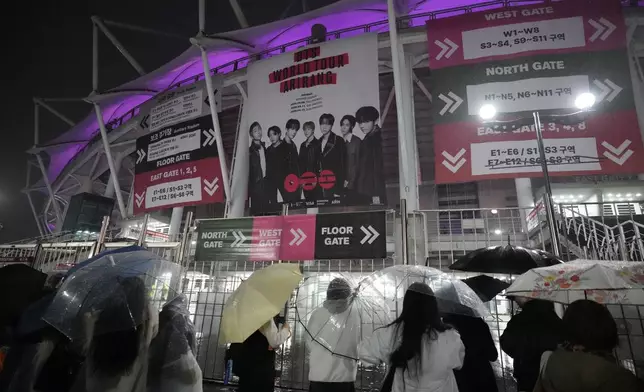 Fans of K-pop band BTS gather outside of the stadium where K-pop band BTS is performing the World Tour Arirang in Goyang, South Korea, Thursday, April 9, 2026. (AP Photo/Lee Jin-man)
