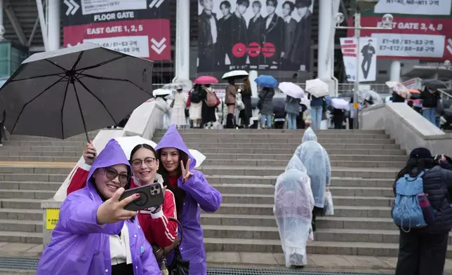 K-pop band BTS fans from Philippines take a souvenir photo at the venue for the BTS World Tour Arirang in Goyang, South Korea, Thursday, April 9, 2026. (AP Photo/Lee Jin-man)