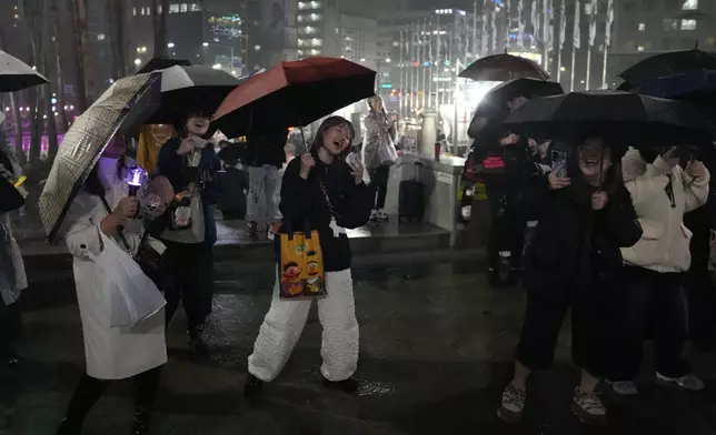 Fans of K-pop band BTS react outside of the stadium where K-pop band BTS is performing the World Tour Arirang in Goyang, South Korea, Thursday, April 9, 2026. (AP Photo/Lee Jin-man)