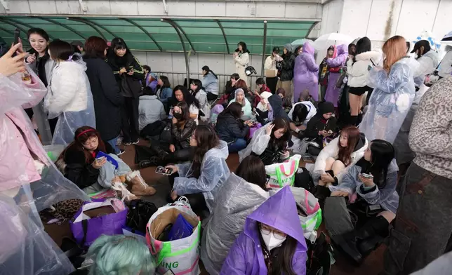 Fans of K-pop band BTS wait for the BTS World Tour Arirang outside of the venue in Goyang, South Korea, Thursday, April 9, 2026. (AP Photo/Lee Jin-man)