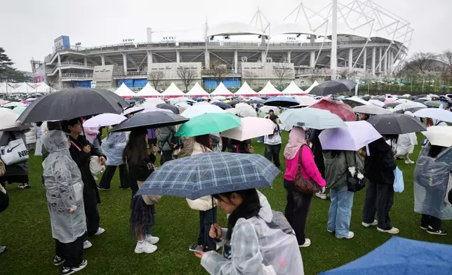 Fans of K-pop band BTS stand in lines at a fan zone for the BTS World Tour Arirang in Goyang, South Korea, Thursday, April 9, 2026. (AP Photo/Lee Jin-man)