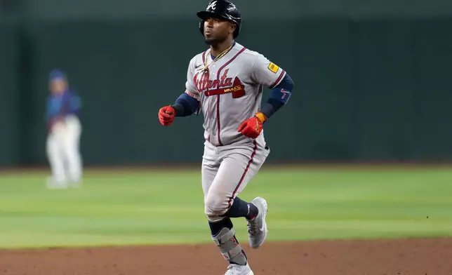 Atlanta Braves second baseman Ozzie Albies (1) rounds the bases after hitting a home run during the ninth inning of a baseball game against the Arizona Diamondbacks, Friday, April 3, 2026, in Phoenix. (AP Photo/Rebecca Noble)