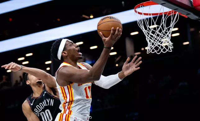 Atlanta Hawks forward Onyeka Okongwu (17) scores during the first half of an NBA basketball game against the Brooklyn Nets, Friday, April 3, 2026, in New York. (AP Photo/Angelina Katsanis)
