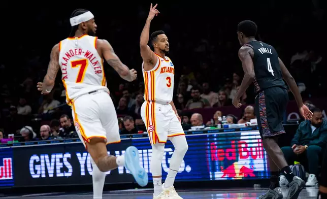 Atlanta Hawks guard CJ McCollum (3) celebrates scoring a three-pointer during the first half of an NBA basketball game against the Brooklyn Nets, Friday, April 3, 2026, in New York. (AP Photo/Angelina Katsanis)