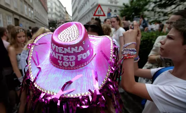 FILE - A person wears a purple head as fans of Taylor Swift also known as Swifties gather in the city centre in Vienna, Aug. 8, 2024. (AP Photo/Heinz-Peter Bader, File)